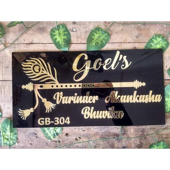 Black and gold personalized family name plate with peacock feather, flute, hanging bells, names and flat number